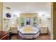 Sunken tub with an abundance of natural light and double vanities at 6010 Old Pageland Marshville Rd, Marshville, NC 28103