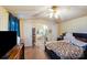 Bedroom featuring a ceiling fan, view into bathroom, and closet at 6010 Old Pageland Marshville Rd, Marshville, NC 28103