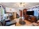 Inviting living room featuring a stone fireplace, ceiling fan, and cozy seating area at 6010 Old Pageland Marshville Rd, Marshville, NC 28103