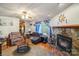 Bright living room features a stone fireplace, hardwood floors, and comfortable seating at 6010 Old Pageland Marshville Rd, Marshville, NC 28103