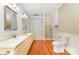 Bright bathroom featuring a double sink vanity, neutral tile, and a glass enclosed shower at 704 Little Creek Dr, Kings Mountain, NC 28086