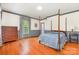Spacious bedroom with hardwood floors and windows dressed in floral curtains at 704 Little Creek Dr, Kings Mountain, NC 28086