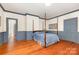 Bedroom with hardwood floors, soft blue accents, and a four poster bed at 704 Little Creek Dr, Kings Mountain, NC 28086