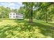Beautiful home showcasing a spacious green lawn, surrounded by mature trees providing shade and privacy at 704 Little Creek Dr, Kings Mountain, NC 28086