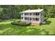 Two-story home featuring a spacious lawn, double-stacked porches, and manicured landscaping at 704 Little Creek Dr, Kings Mountain, NC 28086