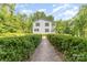 Inviting home with symmetrical facade, trimmed hedges, and a brick path leading to the entrance at 704 Little Creek Dr, Kings Mountain, NC 28086