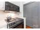 Close-up of kitchen appliances including cooktop and microwave in a bright space at 704 Little Creek Dr, Kings Mountain, NC 28086
