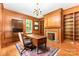 Wood-paneled office featuring a decorative fireplace and ample natural light at 704 Little Creek Dr, Kings Mountain, NC 28086
