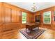 Spacious office features warm wood paneling, a decorative rug, and natural light at 704 Little Creek Dr, Kings Mountain, NC 28086