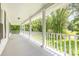 The long porch offers a serene view of the green trees and landscaping, perfect for relaxation at 704 Little Creek Dr, Kings Mountain, NC 28086