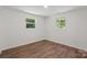 A bright, well-lit bedroom featuring laminate flooring and two windows offering great natural light at 704 W Border St, Dallas, NC 28034