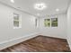 This bedroom features wood floors, recessed lighting, and large windows with lovely natural views at 704 W Border St, Dallas, NC 28034