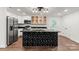 A modern kitchen with stainless appliances, sleek countertops, a geometric black island, and ample cabinet space at 704 W Border St, Dallas, NC 28034