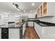 A modern kitchen featuring stainless appliances, sleek countertops, a geometric black island, and plenty of cabinet space at 704 W Border St, Dallas, NC 28034