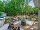 Backyard area features a fire pit, stone waterfall and landscaping at 7300 Bailywick Dr, Waxhaw, NC 28173