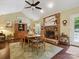 Well-lit dining area featuring hardwood floors, fireplace, and backyard views at 7300 Bailywick Dr, Waxhaw, NC 28173