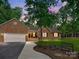 Charming brick home with a well-manicured lawn, inviting front porch, and an attached two-car garage, perfect for suburban living at 7300 Bailywick Dr, Waxhaw, NC 28173