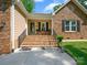 Inviting front porch with brick stairs and charming seating area at 7300 Bailywick Dr, Waxhaw, NC 28173