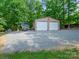 Exterior shot of detached two car garage with gravel driveway at 7300 Bailywick Dr, Waxhaw, NC 28173