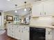 Bright kitchen with white cabinetry, granite countertops, and a black dishwasher at 7300 Bailywick Dr, Waxhaw, NC 28173
