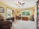 Comfortable home office featuring natural light, a ceiling fan, and relaxing recliner at 7300 Bailywick Dr, Waxhaw, NC 28173