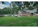 This is a grassy backyard featuring a fence, patio, and the rear exterior of the two-story home at 734 Forestbrook Dr # 10, Gastonia, NC 28056