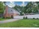 The fenced backyard with a manicured lawn, brick details, and a basketball hoop is ready for outdoor activities at 734 Forestbrook Dr # 10, Gastonia, NC 28056