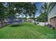 Large grassy backyard with a trampoline, shed, and privacy fence, offering plenty of space for outdoor enjoyment at 734 Forestbrook Dr # 10, Gastonia, NC 28056