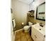 Half bathroom features neutral paint, tile floor, and a mirror with sink and cabinet at 734 Forestbrook Dr # 10, Gastonia, NC 28056