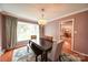 Formal dining room with crown molding, a bay window, and modern chandelier over the dining table at 734 Forestbrook Dr # 10, Gastonia, NC 28056