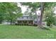 Charming two-story home with brick and siding, a covered front porch, and a well-manicured lawn and mature trees at 734 Forestbrook Dr # 10, Gastonia, NC 28056