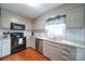 Kitchen with grey cabinets, stainless steel appliances, and hardwood flooring at 734 Forestbrook Dr # 10, Gastonia, NC 28056