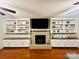 Cozy living room with a brick fireplace, built-in shelves, and hardwood flooring at 734 Forestbrook Dr # 10, Gastonia, NC 28056