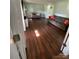 Living room with hardwood floors, grey sofa, and natural lighting at 734 Forestbrook Dr # 10, Gastonia, NC 28056