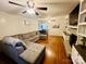 Living room featuring hardwood floors, a comfortable sofa, and a brick fireplace at 734 Forestbrook Dr # 10, Gastonia, NC 28056