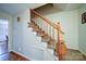 Carpeted staircase with wood railing and decorative banister and a view to another room at 734 Forestbrook Dr # 10, Gastonia, NC 28056