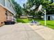Spacious backyard with a patio area, outdoor seating, basketball hoop, and lush green grass at 734 Forestbrook Dr, Gastonia, NC 28056