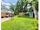 Expansive backyard featuring a seating area, storage shed, mature trees and lush green grass at 734 Forestbrook Dr, Gastonia, NC 28056