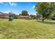 Wide shot of a large backyard with mature trees and outbuildings at 888 Stowe Ln, Gastonia, NC 28056
