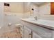 Cozy bathroom with a white single sink vanity, toilet and tile flooring at 888 Stowe Ln, Gastonia, NC 28056