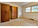 Simple bedroom with neutral carpet, a closet, and natural light from the window at 888 Stowe Ln, Gastonia, NC 28056