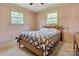 Bedroom featuring neutral carpet, two bright windows and a cozy bed at 888 Stowe Ln, Gastonia, NC 28056