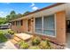 Brick home with a covered entry, mature landscaping, and multi-pane windows at 888 Stowe Ln, Gastonia, NC 28056