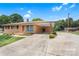 Charming single-story brick home featuring a covered carport and well-manicured landscaping at 888 Stowe Ln, Gastonia, NC 28056