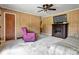 Cozy living room featuring a decorative fireplace, wood paneled walls, and neutral carpet at 888 Stowe Ln, Gastonia, NC 28056