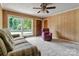 Relaxing living room with a large window, neutral carpet, and wood paneled walls at 888 Stowe Ln, Gastonia, NC 28056
