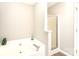 Relaxing bathroom area showcases a luxurious tub with a sleek faucet and a separate glass door shower at 9146 Austin Ridge Ln, Charlotte, NC 28214