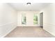 Neutral bedroom boasts large windows for natural light and soft carpeting at 9146 Austin Ridge Ln, Charlotte, NC 28214