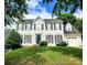 Traditional two-story home with white siding, black shutters, manicured lawn, and mature trees at 9146 Austin Ridge Ln, Charlotte, NC 28214