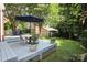 Large backyard featuring a dining set on a patio and a detached garage at 1021 Isleworth Ave, Charlotte, NC 28203